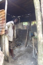 Winston showing me the inside of his stall where he is roasting a breadfruit